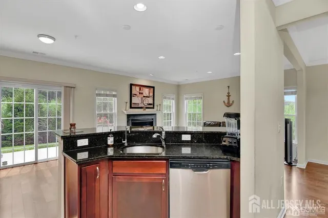 a kitchen with granite countertop a sink and cabinets