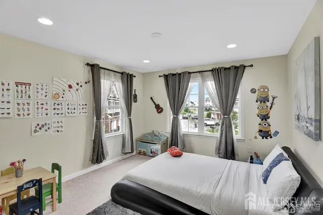 a bedroom with a bed and a large window