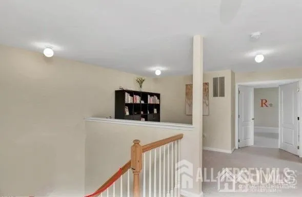 a view of a hallway with a living room