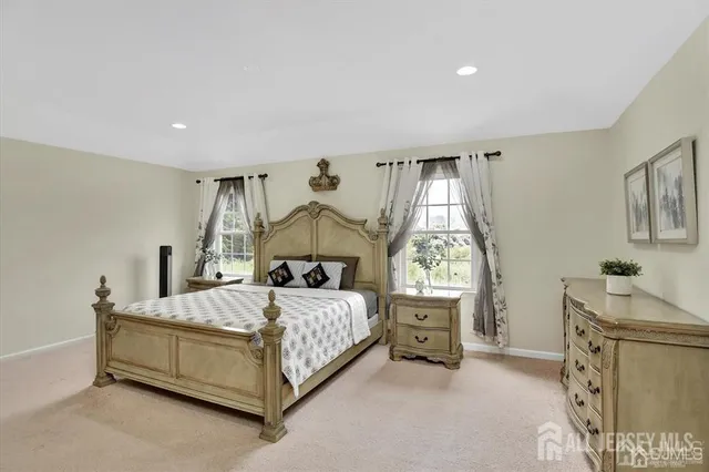 a bedroom with a bed table and window