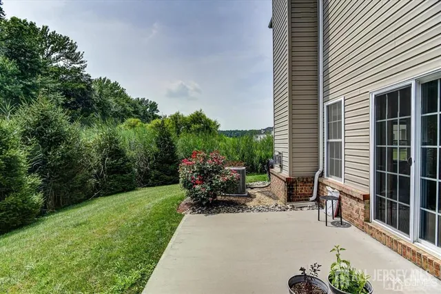 a view of a patio with a table and chairs and potted plants