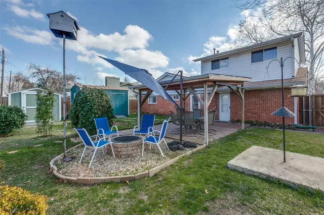 a view of a house with a yard porch and furniture
