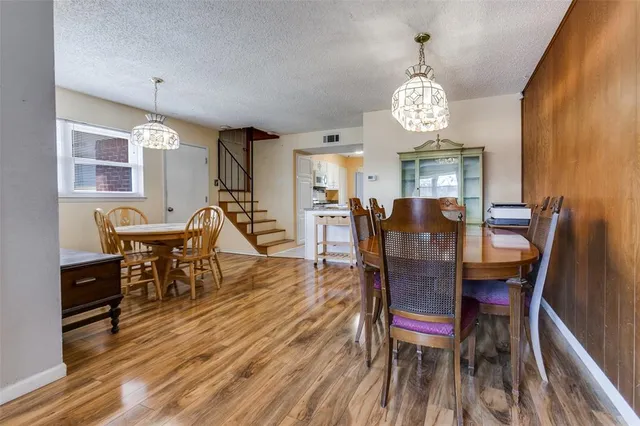 a view of a dining room with furniture wooden floor and chandelier