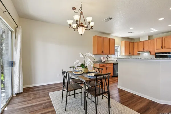 a view of a dining room with furniture wooden floor and chandelier