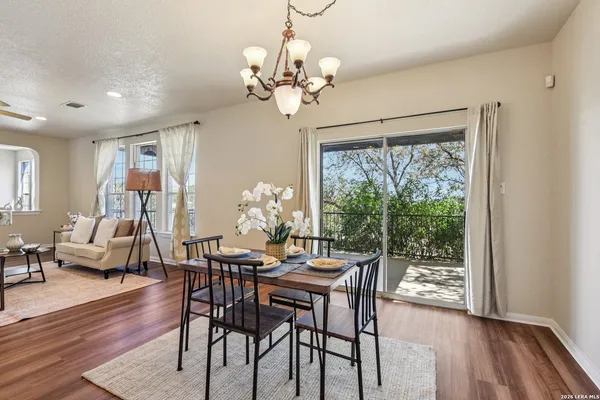 a kitchen with stainless steel appliances granite countertop a refrigerator a stove top oven and sink with wooden floor