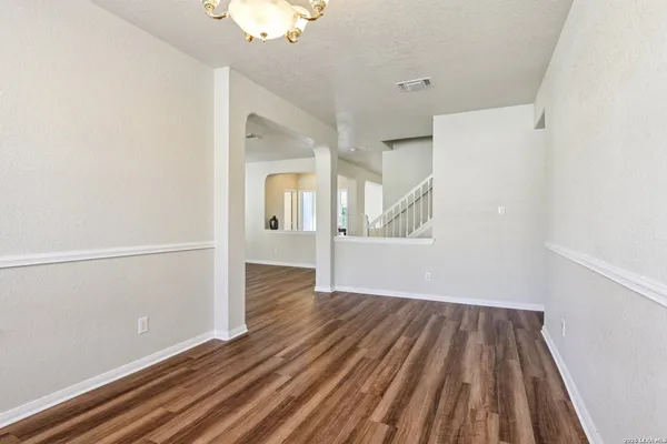 a bathroom with a granite countertop toilet a sink and mirror