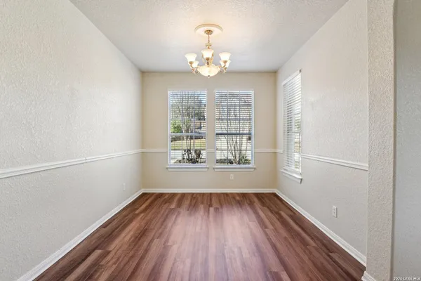 a view of a workspace with furniture and window
