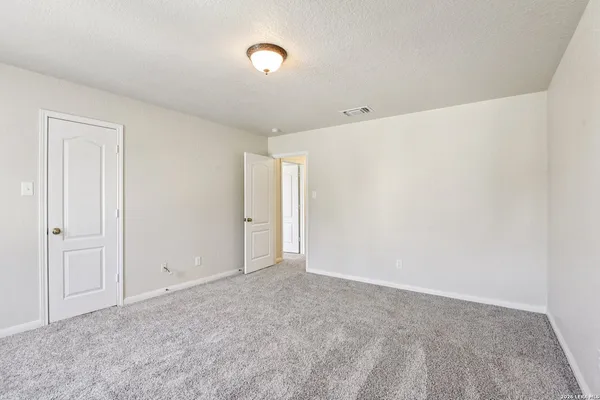 a bedroom with a bed and ceiling fan
