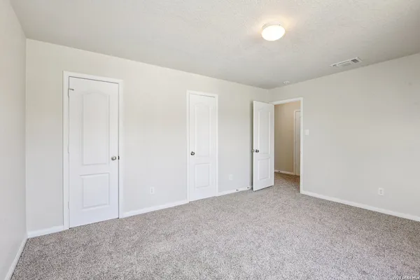 a bathroom with a granite countertop sink a mirror and a shower