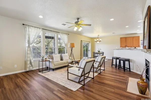 a living room with furniture and a wooden floor