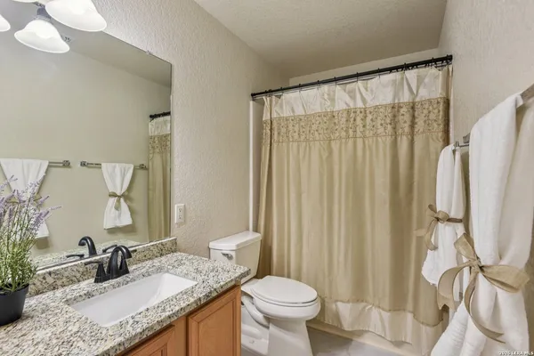 a front view of a house with a tree