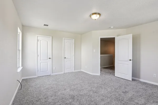 an aerial view of a house with outdoor space and trees around