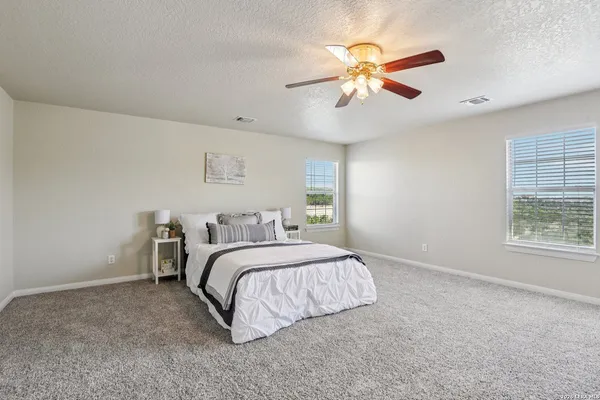 an aerial view of residential houses with outdoor space and trees