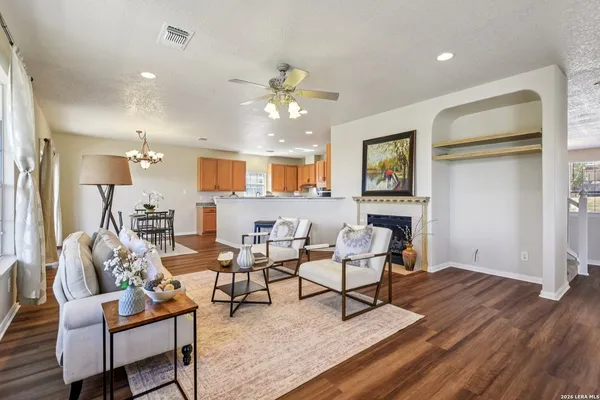 a living room with furniture and a wooden floor