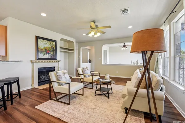 a living room with furniture and a wooden floor
