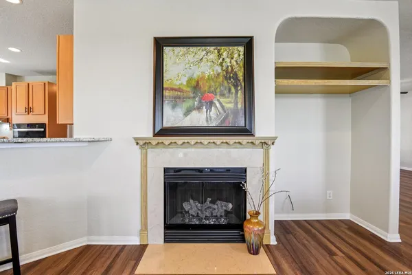 a living room with a fireplace and wooden floor