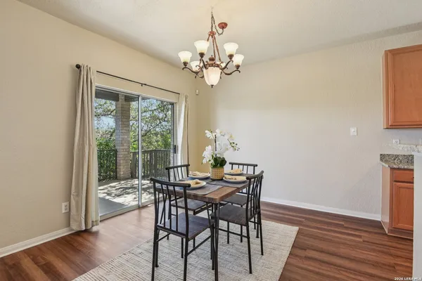 a view of a dining room with furniture wooden floor and chandelier