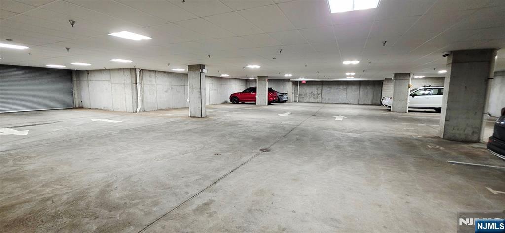 235 Ridge Road North Arlington, NJ 07031 - Photo 13 of 13 an empty room with kitchen view and a refrigerator