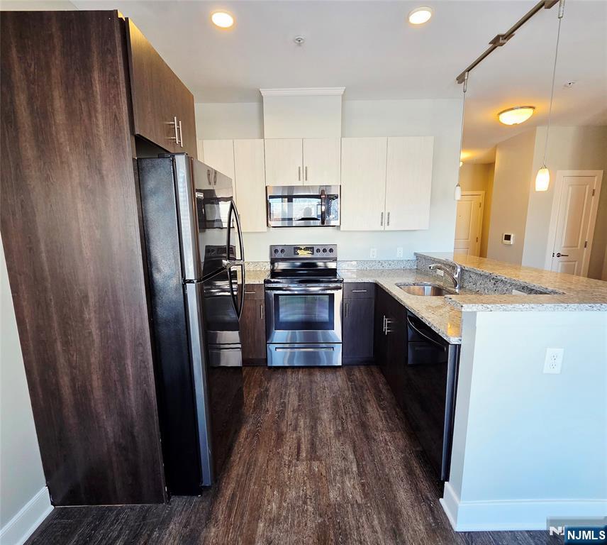 235 Ridge Road North Arlington, NJ 07031 - Photo 5 of 13 a kitchen with stainless steel appliances a refrigerator and wooden floor