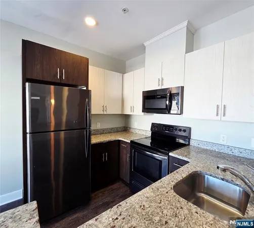 a kitchen with a refrigerator sink and microwave
