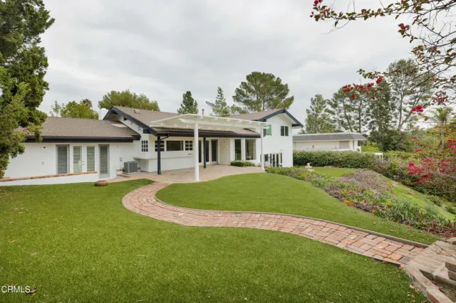a front view of a house with a yard table and chairs