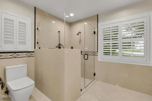 a bathroom with a toilet a sink and a shower