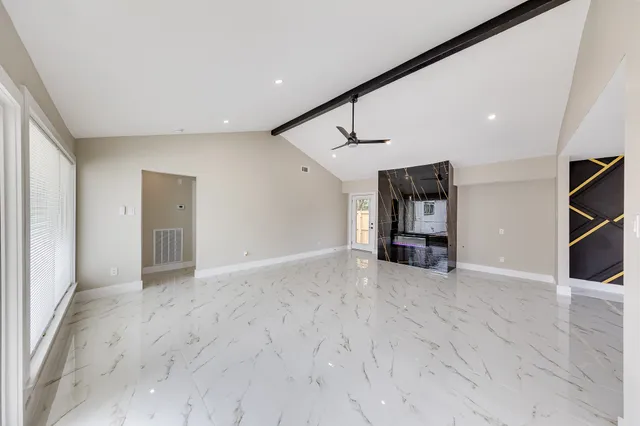 a view of a livingroom with furniture and a ceiling fan