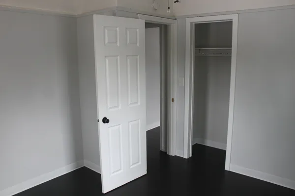 an empty room with wooden floor