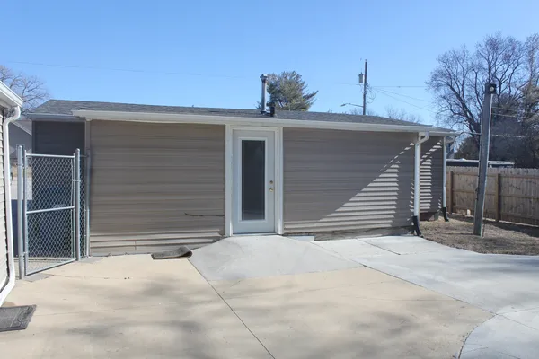 a view of house with yard and garage