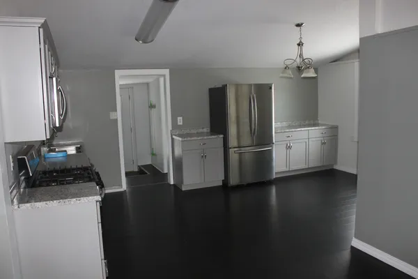 a kitchen with stainless steel appliances a refrigerator and a stove top oven