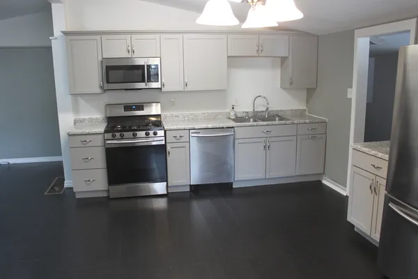 a kitchen with stainless steel appliances a sink stove and refrigerator