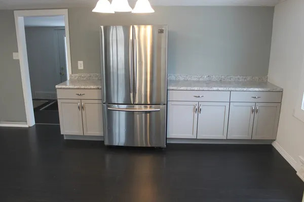 a view of a storage & utility room with closet wooden floor and windows