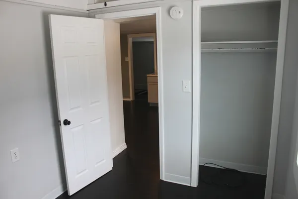 a view of a hallway with wooden floor