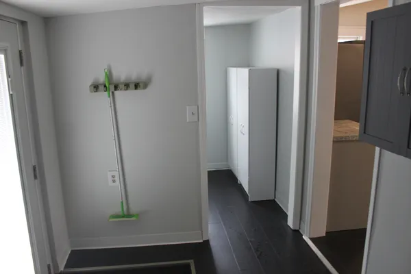 a view of hallway with wooden floor