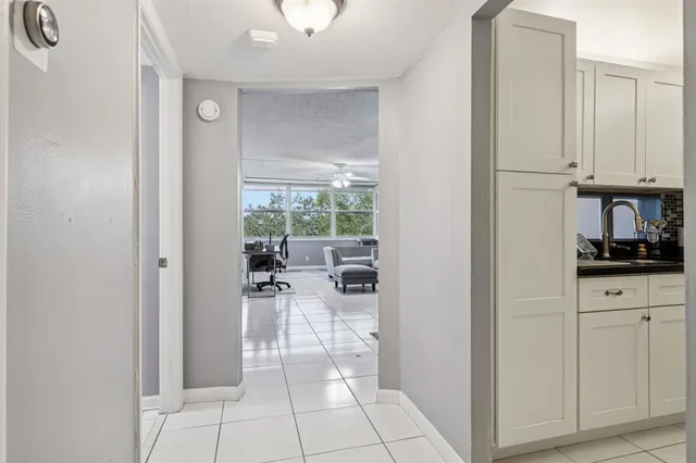 a kitchen with granite countertop a refrigerator and a sink