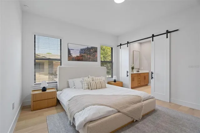 a bedroom with a large bed and a window