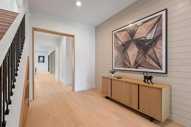 a view of a hallway with wooden shelves