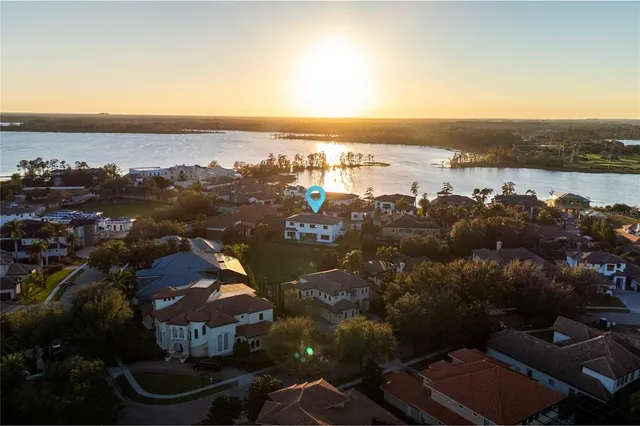 an aerial view of a house with a garden and lake view