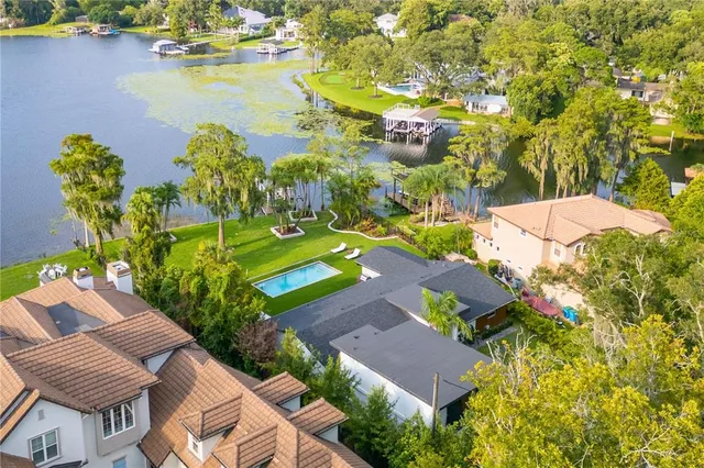an aerial view of residential house with outdoor space and swimming pool