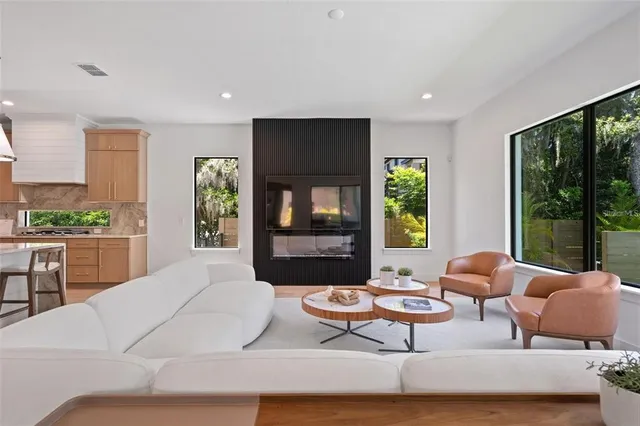 a living room with furniture and large windows