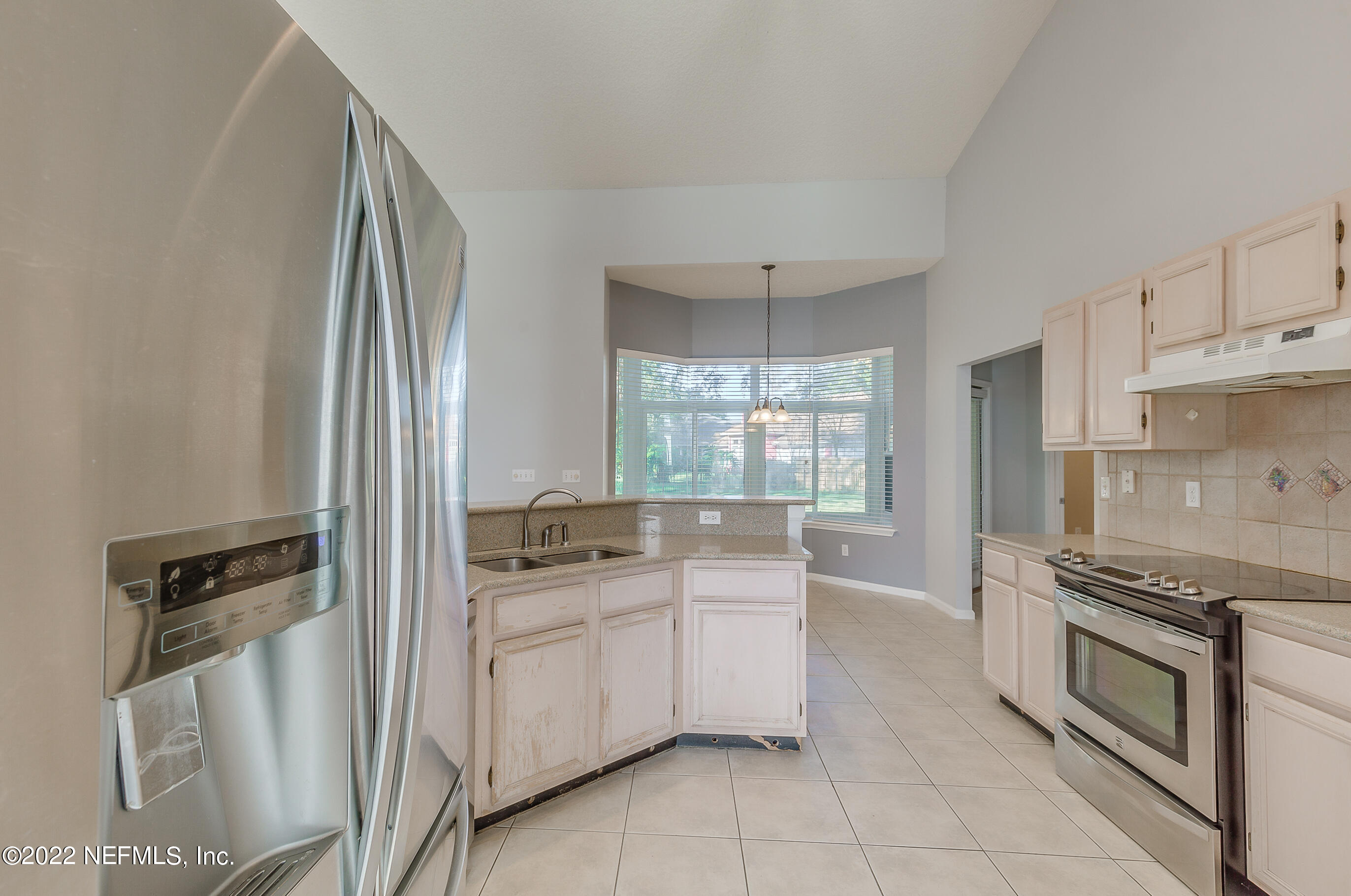 2004 Water Crest Drive Fleming Island, FL 32003 - Photo 15 of 51 a kitchen with white cabinets and appliances