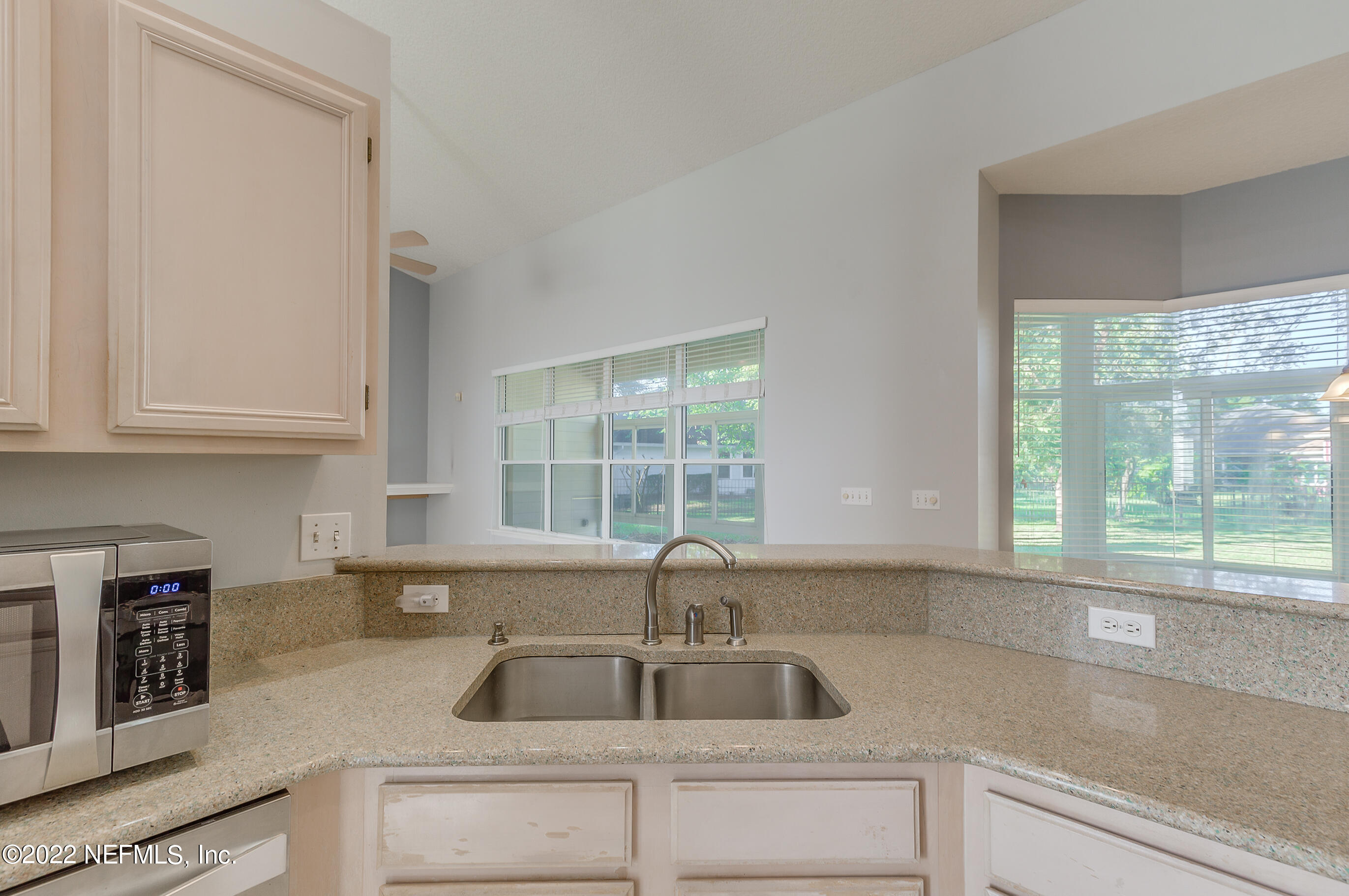 2004 Water Crest Drive Fleming Island, FL 32003 - Photo 18 of 51 a kitchen with granite countertop a sink and a window
