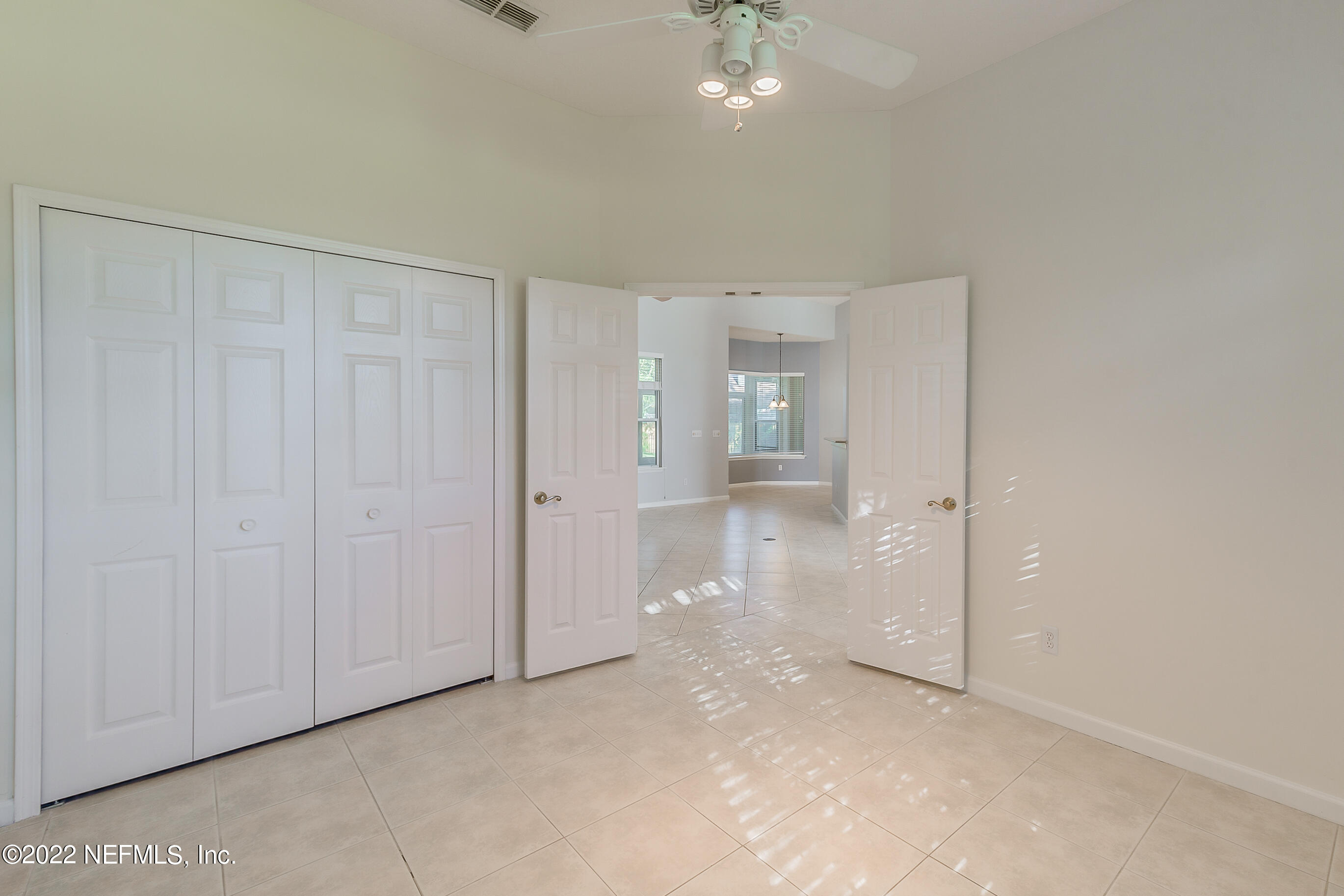 2004 Water Crest Drive Fleming Island, FL 32003 - Photo 26 of 51 an empty room with chandelier fan and bathroom