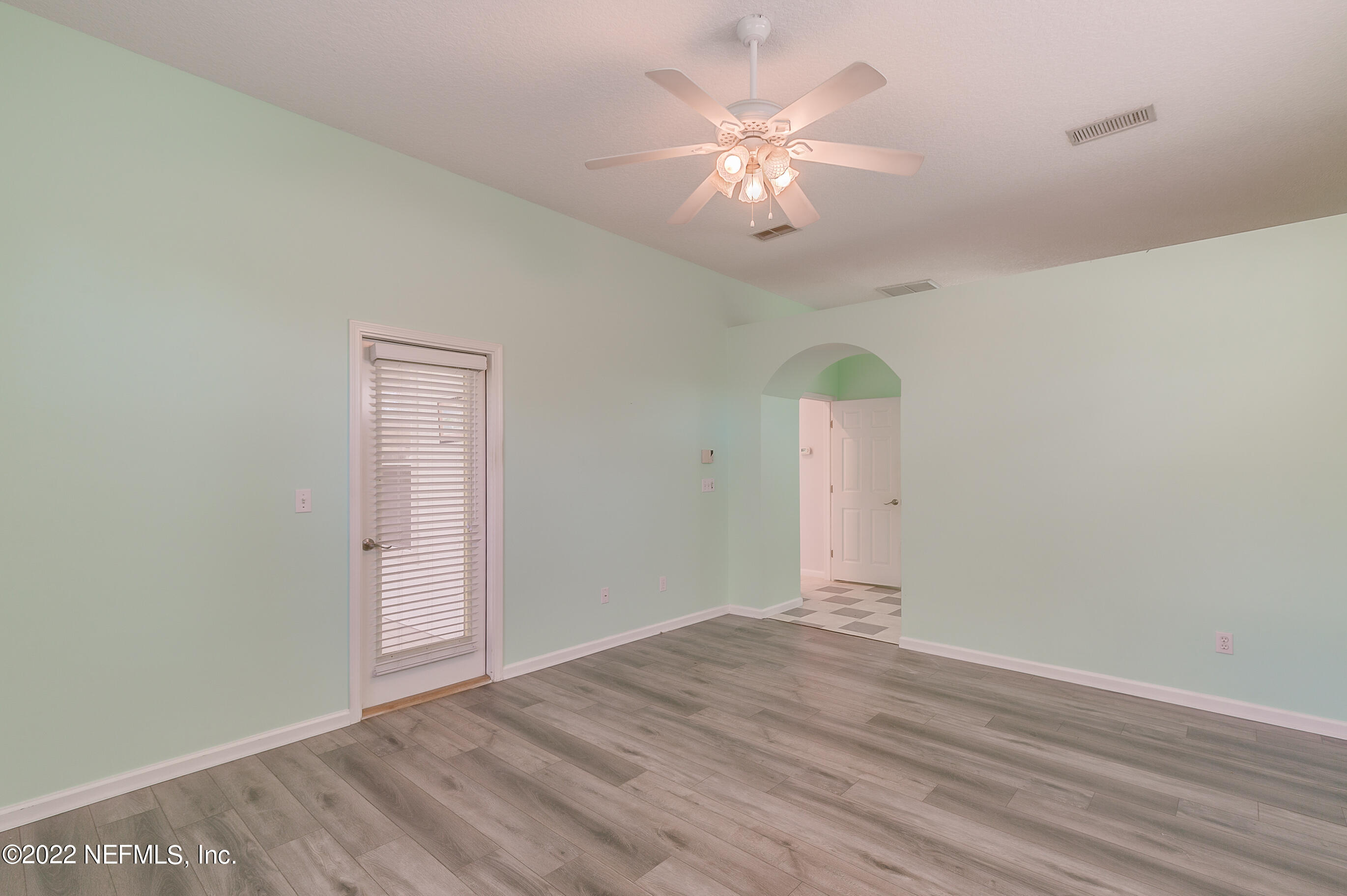 2004 Water Crest Drive Fleming Island, FL 32003 - Photo 29 of 51 an empty room with wooden floor chandelier fan and windows