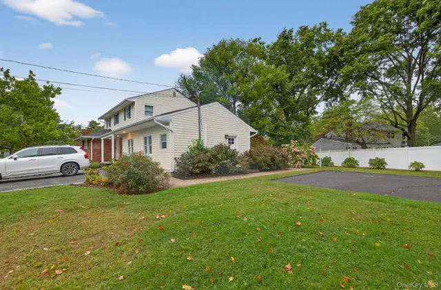 a front view of house with yard and trees