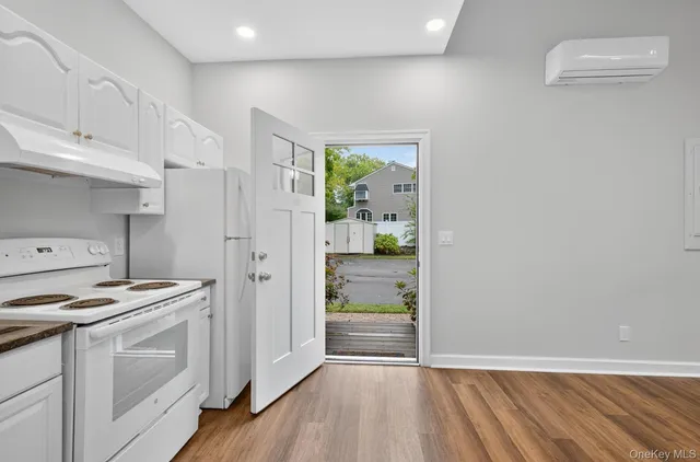 a kitchen with white cabinets and white appliances