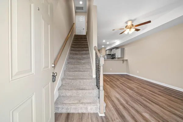 a view of entryway and hall with wooden floor