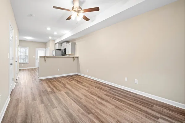 a view of a kitchen with wooden floor and a sink