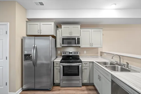 a kitchen with a refrigerator stove and microwave