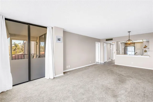 a view of a hallway with painting on the wall